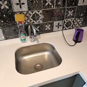 a kitchen sink with a faucet on a counter at Home in love in Esenyurt