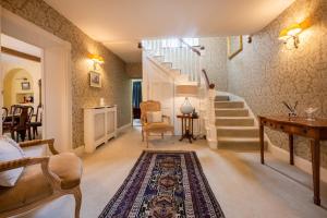 a living room with a staircase and a rug at Ivy Farm in Grimston