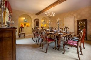 a dining room with a wooden table and chairs at Ivy Farm in Grimston