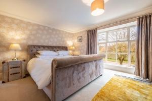 a bedroom with a large bed and a window at Ivy Farm in Grimston