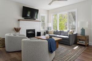 a living room with two couches and a fireplace at Idyllic Asheville Countryside Home on 70 Acres in Mars Hill