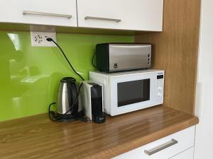 a microwave sitting on top of a kitchen counter at alscher's holiday home in Interlaken +43 photos