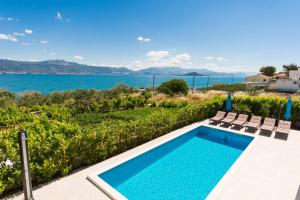a swimming pool with a view of the water at Villa Piramida in Trogir