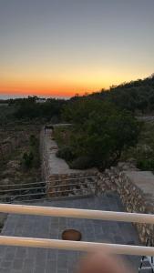 un conjunto de escaleras con una puesta de sol en el fondo en Chalets in the middle of Ajloun forests شاليه و مزرعة في وسط غابات عجلون, en Ajloun