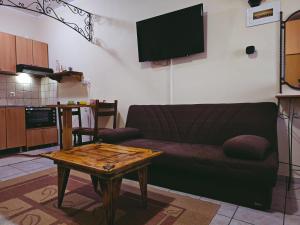a living room with a couch and a table at Studio GIANNIS in Souflíon
