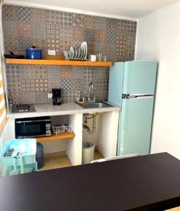 a kitchen with a blue refrigerator and a sink at Villa Esterito in La Paz +20 photos