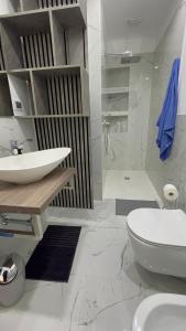 a bathroom with a sink and a toilet and a shower at Apartament Design & Comfort in centro in Genoa