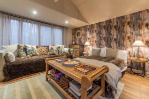 a living room with a bed and a table at The Bothy in Ringstead