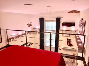 a room with a red bed and a staircase at [Loft in centro] Boutique 65 in Turin