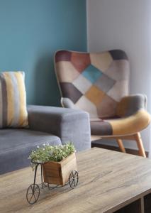 a living room with a couch and a table with a plant at Sitia Cozy Apartment in Sitia