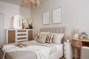 a bedroom with a bed with a mirror and a desk at ŻOLI STORK APARTMENTS - Hubnera 5 in Warsaw