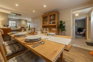 a dining room with a wooden table with wine glasses at Foxhill House in South Creake