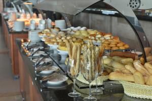 uma linha de buffet com copos de vinho e pão em Malai Manso Resort Yatch Convention & Spa em Retiro