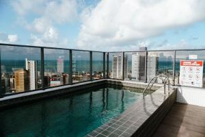 a swimming pool on the roof of a building at One Way in João Pessoa