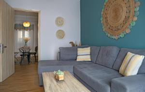 a living room with a blue couch and a table at Sitia Cozy Apartment in Sitia