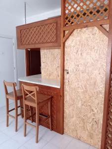 a kitchen with a table and chairs and a bed at Cacilhas Mini Hostel in Cacilhas