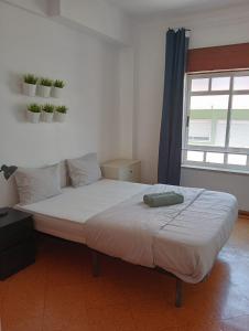 a large bed in a room with a window at Cacilhas Mini Hostel in Cacilhas +29 photos