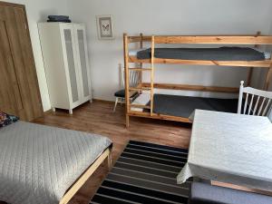 a room with two bunk beds and a chair at Johnny House in Suwałki