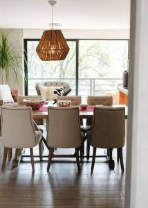 a dining room with a table and chairs at Mr. W Park View Balcony Espana 602 in Mexico City