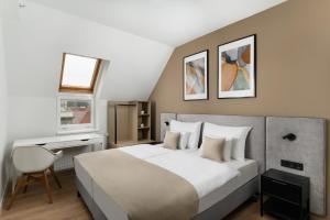 a bedroom with a bed and a desk and a chair at Florin Apart Hotel in Budapest