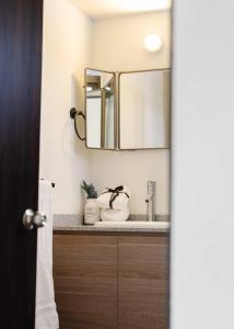 a bathroom with a sink and a mirror at Mr. W Park View Balcony Espana 602 in Mexico City