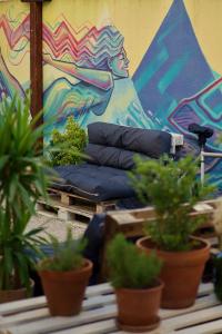 a mural of a baseball player on a wall with potted plants at Backpackers Home in Zadar