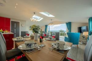 a dining room with a wooden table with wine glasses at Sunset in Overstrand