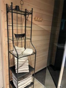 a towel rack in a sauna with towels at Chalet Sint-Hubertus Deluxe in Zutendaal