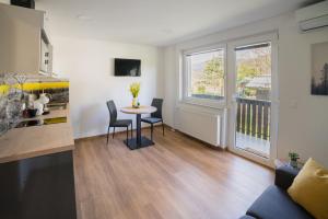 a kitchen and living room with a table and chairs at Apartma Lida 1 in Bled