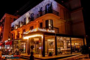 una tienda frente a un edificio con luces de Navidad en PREMIUM INN City Hotel & Restaurant Central Shopping Street Location !, en Famagusta