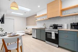 a kitchen with blue cabinets and a table and a kitchen with a couch at The Olympia: Front Street Flats in Belleville