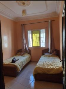 1 Schlafzimmer mit 2 Betten und einem Fenster in der Unterkunft Agadir in Agadir