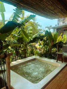 a hot tub in the middle of a garden at Hotel Shibari - Restaurant & Cenote Club in Tulum