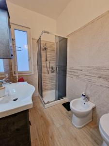 uma casa de banho com um chuveiro, um WC e um lavatório. em Incanto em Sestu
