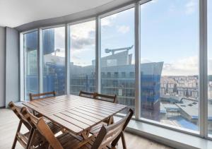 a wooden table and chairs in a room with windows at Luxurious Residence in Istanbul in Istanbul