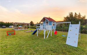 a playground with a house and a slide at Amazing Home In Jaroslawiec With House A Panoramic View in Jarosławiec