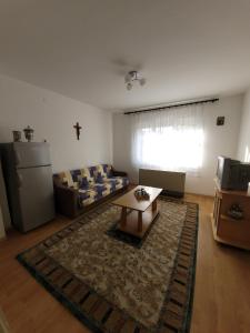 a living room with a couch and a coffee table at Centar Apartment in Gevgelija