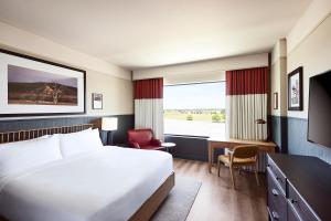 a hotel room with a large bed and a desk at The Scarlet, Lincoln, a Tribute Portfolio Hotel in Lincoln