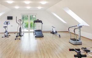 a gym with treadmills and exercise bikes in a room at 1 Bedroom Gorgeous Home In Choczewo in Choczewo