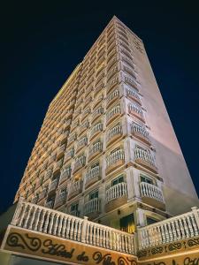 a tall white building with balconies on the side of it at Hotel da Villa in Fortaleza