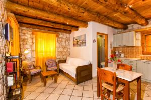 a living room with a bed and a kitchen at Liuba Villas in Vasilikos