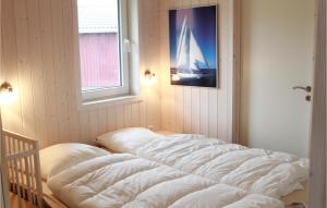 a bed in a room with a picture of a sailboat at Friedrichskoog-Deichblick 22 in Friedrichskoog
