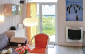 a living room with a chair and a television at Friedrichskoog-Deichblick 22 in Friedrichskoog