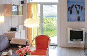 a living room with a chair and a television at Friedrichskoog-deichblick 22 in Friedrichskoog