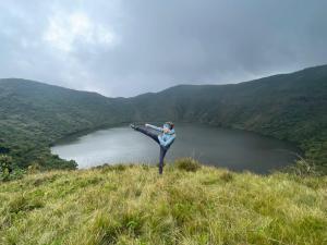 a person standing on top of a hill near a lake at Leisure Safaris and Inns in Ruhengeri