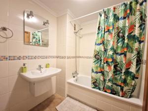 a bathroom with a sink and a shower curtain at Apartment in La Tejita 2 in La Tejita