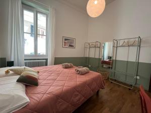 a bedroom with a large bed with two stuffed animals on it at il Mandorlo - a due passi dal porto antico in Genova