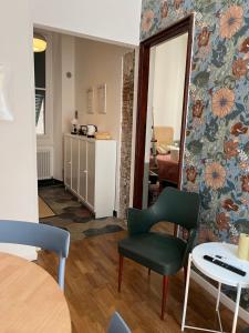 a living room with a chair and a table at il Mandorlo - a due passi dal porto antico in Genova