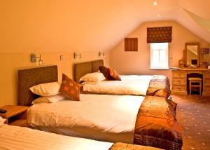 a bedroom with three beds in a room at New Dungeon Ghyll Hotel in Great Langdale