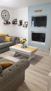 a living room with a couch and a coffee table at Lower Main Street Apartment in Letterkenny